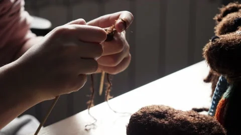 A young woman's hands knit with needles. Stock Footage 239051148
