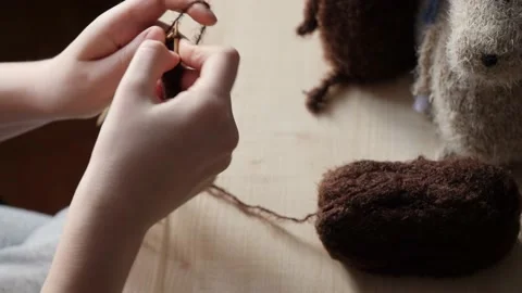 A young woman's hands knit with needles. Video stock 239051158