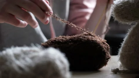 A young woman's hands knit with needles. Video stock 239051178