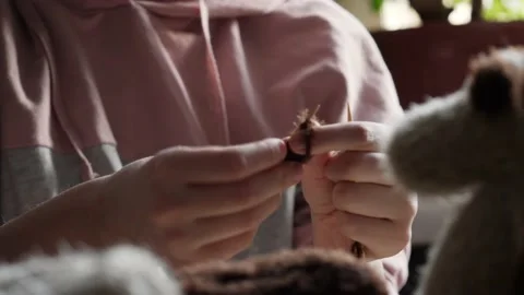 A young woman's hands knit with needles. Video stock 239051186