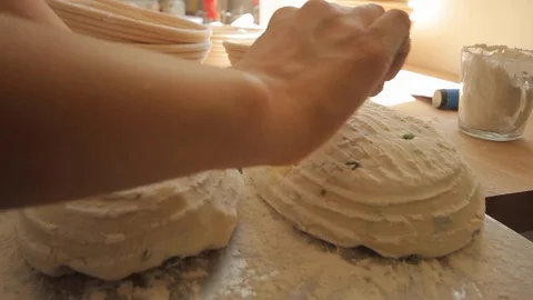 Young woman's hands marking dough for bread Stock Footage 130040011