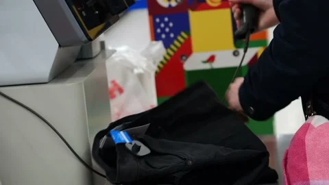 A young woman's hands scan things at the self-service checkout counter. Stock Footage 228988962
