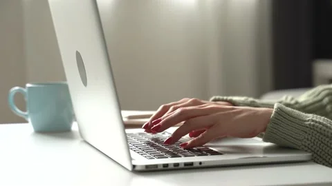 Young womans hands typing on laptop at home Stock Footage 168337659