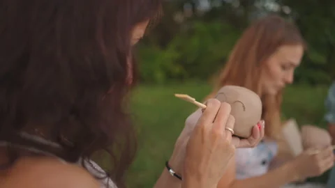 Young women apply a pattern, a drawing on clay products with the help of tools Stock Footage 160908919