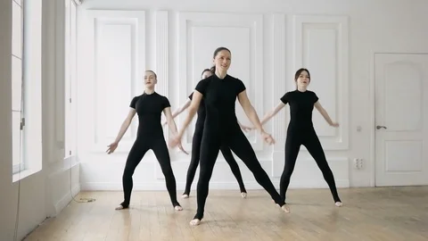 Young women doing exercise while warming up in light style gym space Stock Footage 86316508