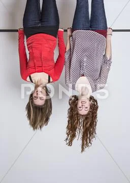 Young Women Hanging Upside Down, Smiling