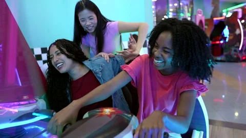 Young women having fun playing arcade game Stock Footage 308262247