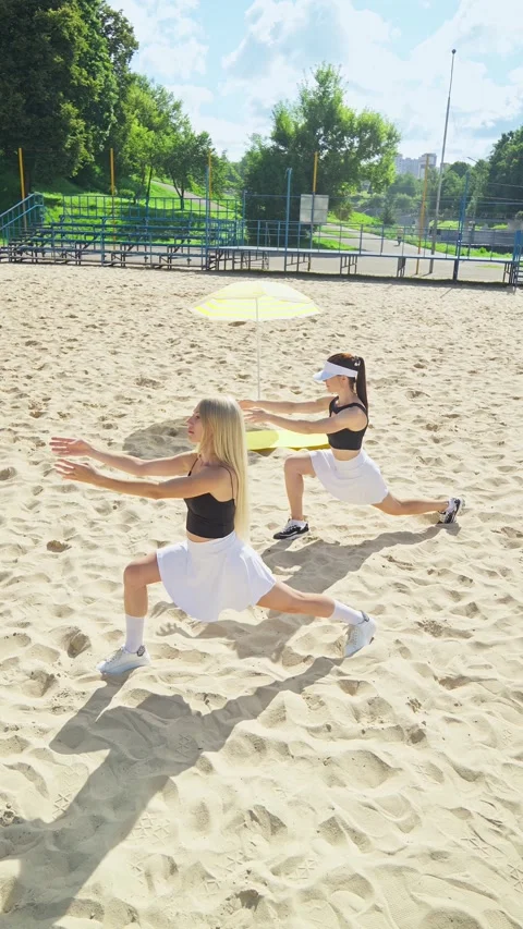 Young women performing dynamic workout on sandy beach grounds Video stock 315859859