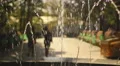 Young women strolling and sitting on bench. Female friends meeting in city park. HD Footage