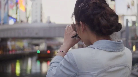 Young women using DSLR camera photos in Namba Bridge Japan Stock Footage