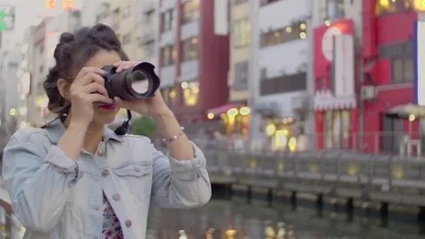 Young women using DSLR camera in Dotombori Osaka Japan  스톡 동영상 76123857