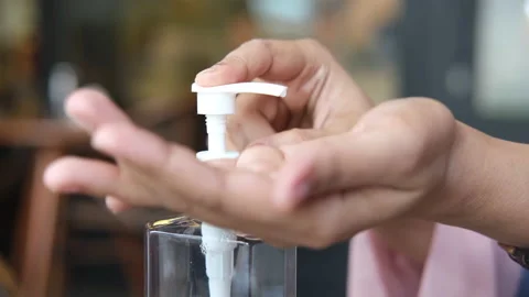 Young women using hand sanitizer at cafe Stock Footage 149302844