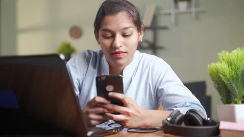 Young women is using mobile while in work Stock Footage 147171375