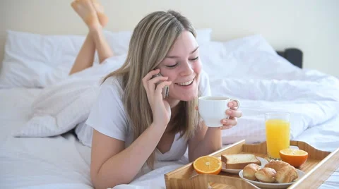 Young women using phone and drinking coffee Stock Footage 59221482