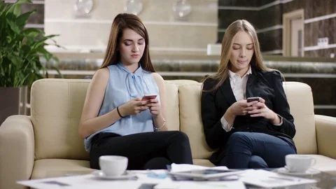 Young women using their smartphones. woman having success Stock Footage
