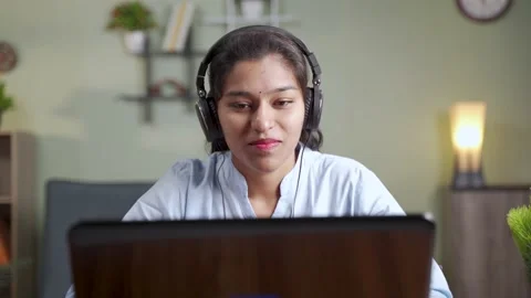Young women is virtual meeting in laptop with wearing head set Stock Footage