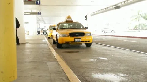Young womenl catching a cab at the airport HD9327 Stock Footage