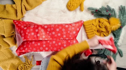 Young Women's hands pack a New Year's gift. Christmas gift New Year layout Stock Footage 211885541