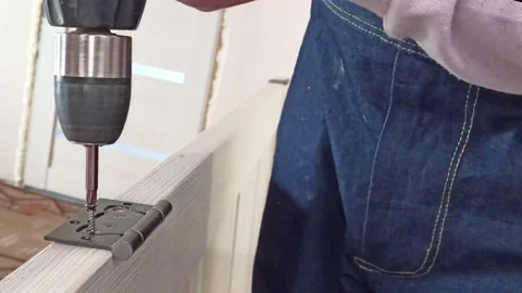 A young worker assembles an interior door Stock Footage 159484675
