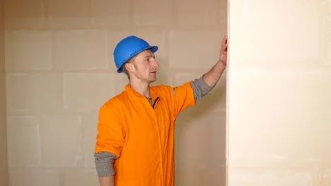 Young Worker checking the wall with level tool Stock Footage 71940425