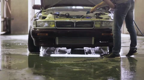 Young worker dries engine Stock Footage