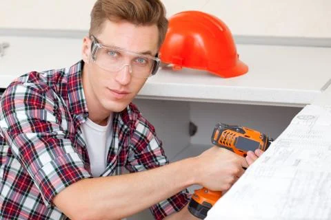 Young worker with drill Stock Photos