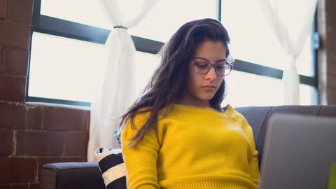 Young worker with glasses on a laptop, at the end she closes her computer Stock Footage 126237933