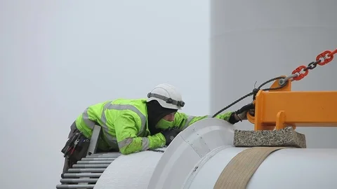 Young Worker in Green Jacket Bowing Above the Blade Stock Footage 72186184