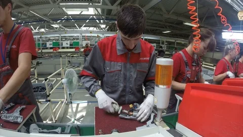 Young Worker in Grey and Red Jacket Assembles Drill Stock Footage 73869456