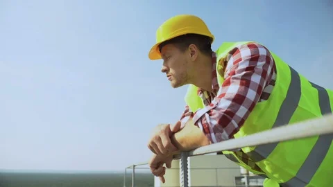 Young worker leaning building rails standing outdoors, construction occupation 스톡 동영상 117218948