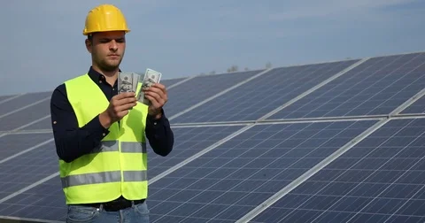 Young Worker Man Count Money Payday Salary in Usd Bills Solar Panels Energy Job Stock-Footage 73588486