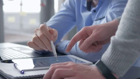 Young worker pointing at tablet screen while listening for observations. Stock Footage 82227794