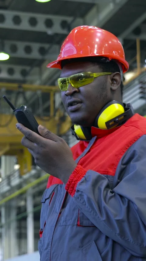 Young Worker in Protective Workwear Talking Over Radio Communication Device Stock Footage 312734269