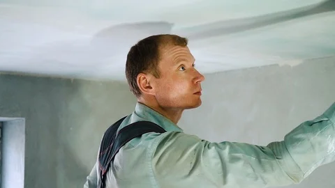 Young worker putty the ceiling in the room. Interior Design 動画素材 126748838