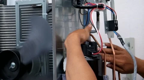 Young worker sets split system air conditioner outdoor Stock Footage 41511911