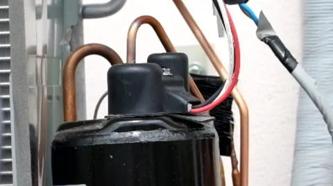 Young worker sets split system air conditioner outdoor Stock Footage 41512054