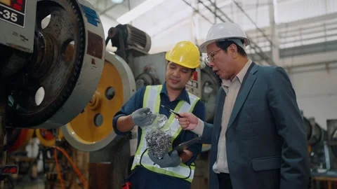 Young worker shows scrap metal to supervisor Stock Footage 341651630