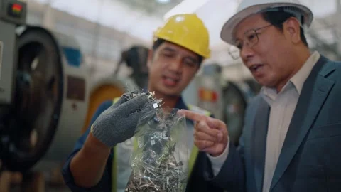 Young worker shows scrap metal to supervisor Stock Footage 341651690