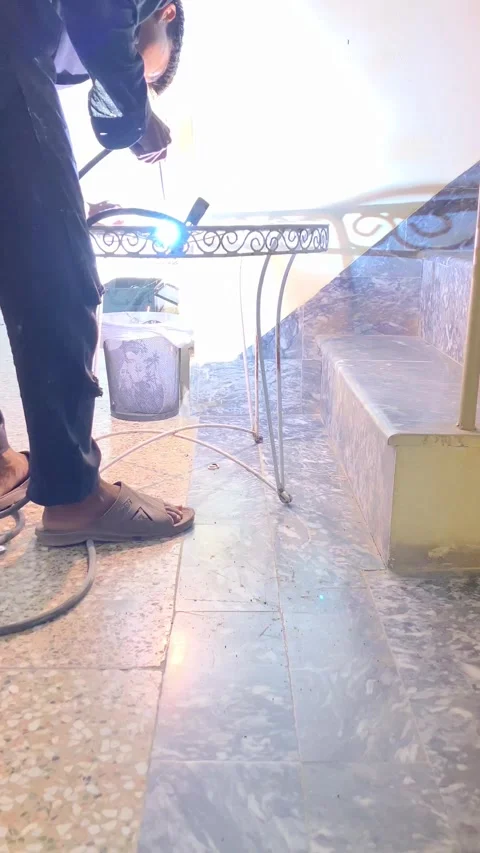 A young worker is welding an old metallic chair in slow motion. Stock Footage 340410960