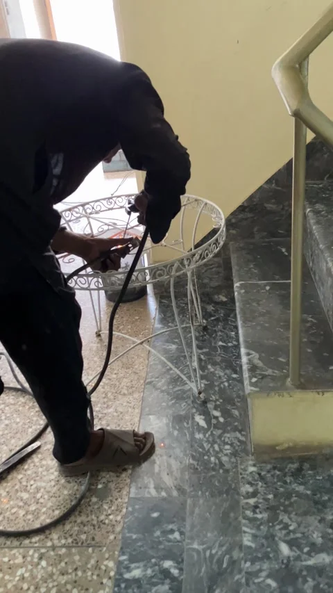 A young worker is welding an old metallic chair in slow motion. Stock Footage 340410962