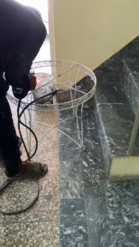 A young worker is welding an old metallic chair in slow motion. Stock Footage 340410980