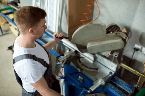 Young worker in windows workshop Foto stock