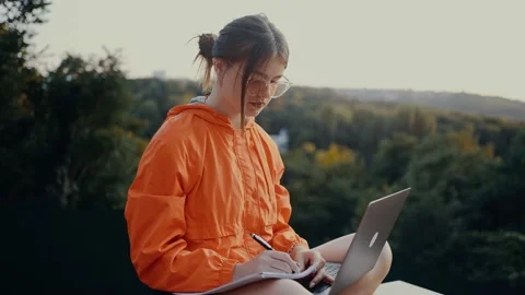 The young worker writes down her to-do list to achieve this month's goals, in Stock Footage 162905107