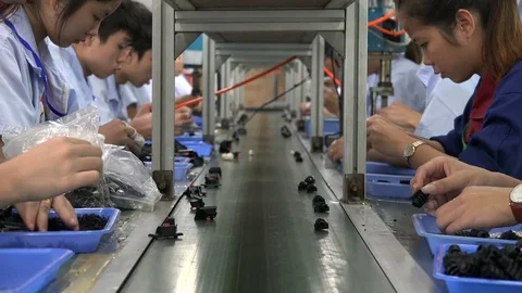 Young workers at the assembly line of an electronics factory in Shenzhen, China Stock Footage 71490975