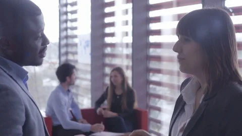 Young workers communicating in pairs at the modern office Stock Footage 74284978