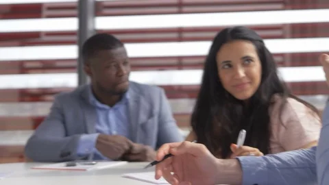 Young workers discussing new developments in a meeting room Stock Footage 73859432