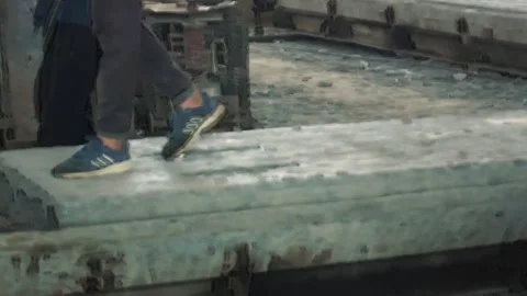 Young workers work with a shovel at a cement factory. Stock Footage 245944102