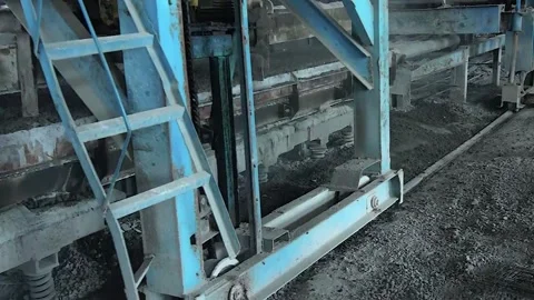 Young workers work with a shovel at a cement factory. Stock Footage 245944124