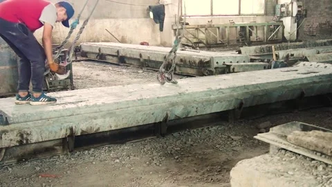 Young workers work with a shovel at a cement factory. Stock Footage 245944170
