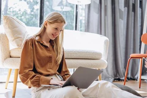 Young working mom working from home on her laptop Stock Photos